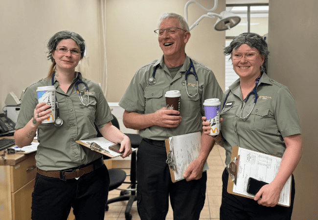 three doctors standing in a hallway